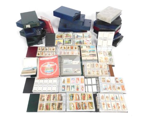 Cartophily and Deltiology. A quantity of cigarette trade and tea cards, postcards, etc., comprising trade cards, train postca
