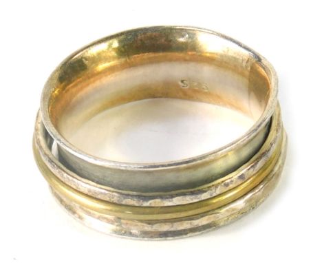 A dress ring, of curved outer design with hammered three band interior, white metal stamped 925, ring size R½, 7.8g all in. 