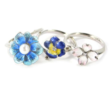 Three silver and enamel floral dress rings, comprising a blue floral dress ring with central cultured pearl, ring size M½, a 