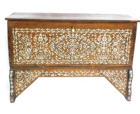 A 19thC Syrian hardwood marriage chest, with mother of pearl and bone inlay, the hinged lid over a panelled front, raised on 
