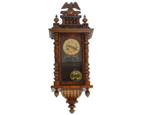 A late 19thC American oak cased wall clock,  circular brass dial embossed with flowers, chapter ring bearing Roman numerals, 