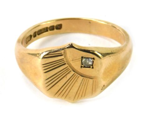 A 9ct gold signet ring, with an engraved quarter sunburst ring head, set with round brilliant cut tiny diamond, in four claw 