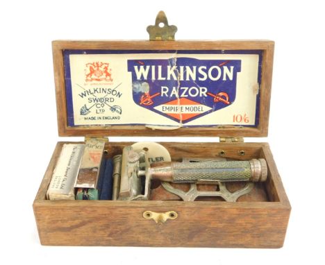 A Wilkinson Empire Model razor, with some attachments, card, etc, in hardwood box, 12.5cm wide.