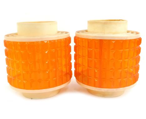 A pair of 1970's lamp shades, each with a cream plastic rim, with pointed orange shade, 25cm high. 