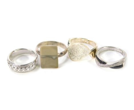 Four dress rings, comprising a silver wave design dress ring, ring size O, a silver and cz amore half hoop dress ring, ring s