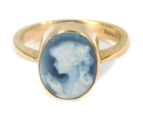 A 9ct gold blue agate cameo dress ring, with figure looking left, in a rub over setting on plain design band, size N 1/2, 3.4