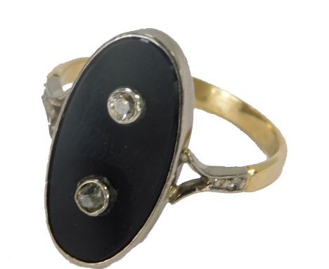 A Victorian oval dress ring, the central oval onyx in a rub over white gold setting, two central diamonds and diamond set sho