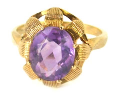 A 9ct gold amethyst dress ring, with oval amethyst in eight claw setting with petal design, size K, 3g all in.