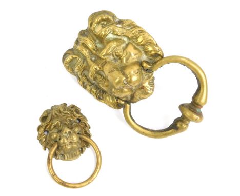 A brass lion's mask door knocker, 13.5cm wide, together with a smaller example, 7cm wide. (2)