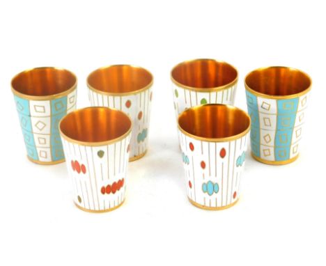 Six enamel beakers, each with a gilt interior, comprising a set of four with white beaded enamel, and turquoise and white ena
