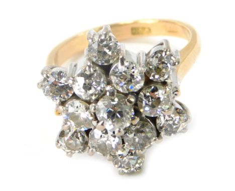 An 18ct gold diamond cluster ring, with star arrangement, each stone rose cut, the central stone approx 0.31ct, surrounded by
