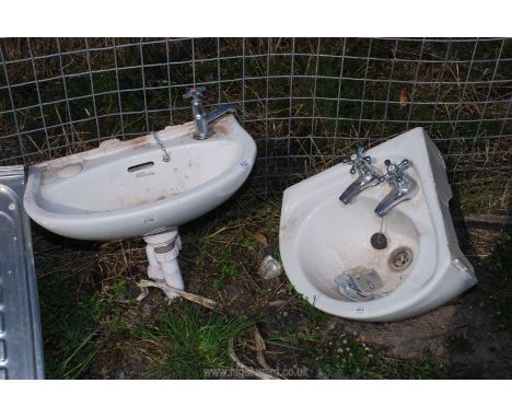 A corner hand basin with taps.