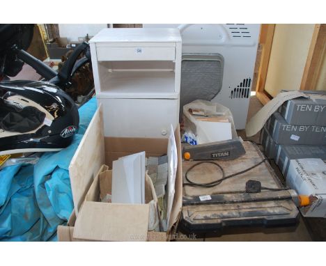 A tile cutter, various tiles and a bedside lamp.