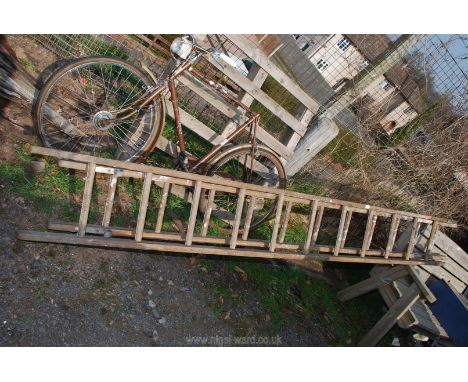 An 11 rung double wooden ladder.