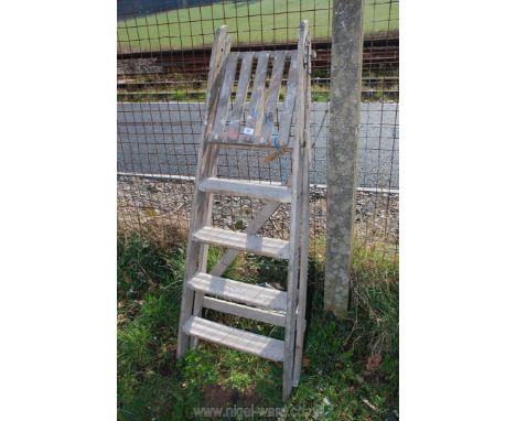 A four rung wooden step ladder.