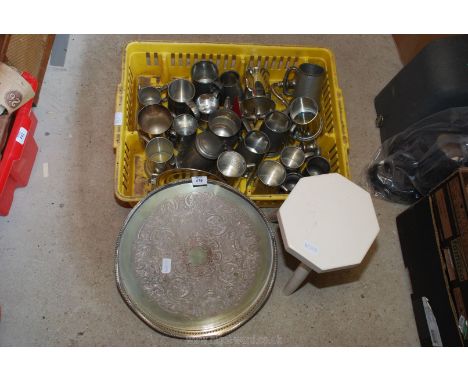 A quantity of tankards and a three legged milking stool.