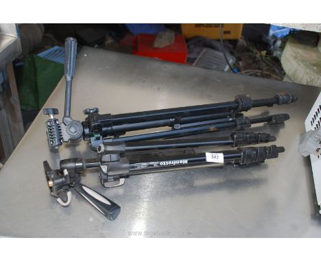 Two modern camera tripods, quick release plates not present.