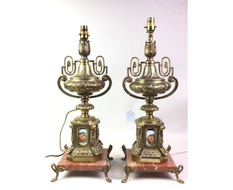 PAIR OF CAST METAL AND MARBLE TABLE LAMPS, each of urn form, mounted with ceramic panels depicting scenes of lovers on four p
