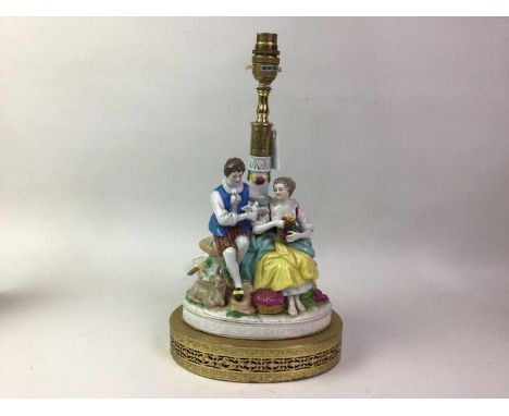 PORCELAIN FIGURE GROUP TABLE LAMP, modelled as a male and female with various animals, raised on a gilt metal stand, along wi