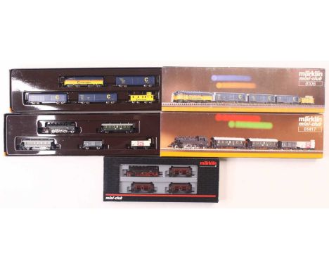 Three Marklin Mini Club Z gauge train packs, including a DB BR 86 class in black, with three hopper wagons, a DB BR 86 class 
