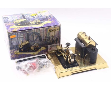Wilesco D10 steam engine, comprising a horizontal boiler, in brass, a detachable chimney, in black, and a single-cylinder eng