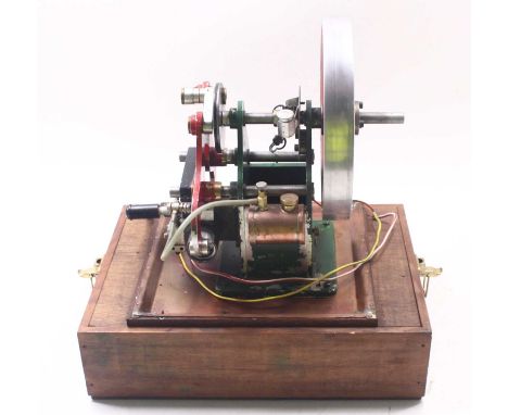 A large stationary 4-stroke petrol engine, comprising a 9-inch flywheel, an ignition system, a lubricating system, and two pi
