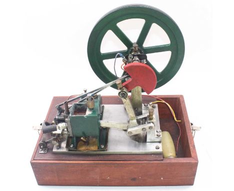 A large scratch-built 4-stroke stationary petrol engine, comprising a 10-inch flywheel, an ignition system, a single cylinder