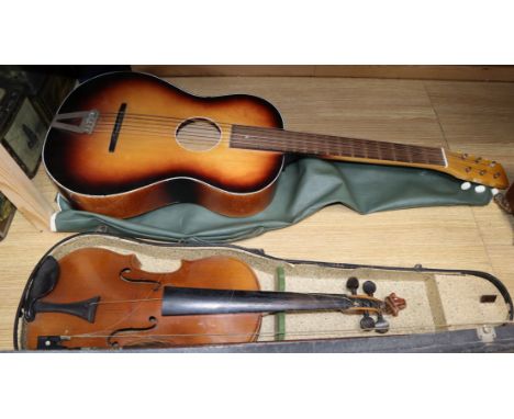 A cased violin, bow and a guitar