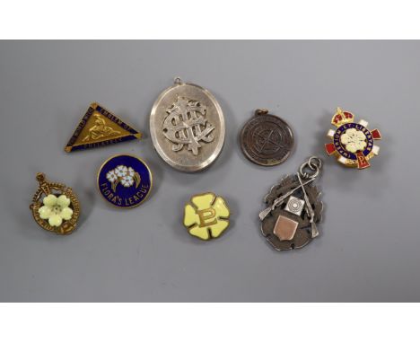 A Victorian silver locket and a silver rifle medal, enamel badges, etc.