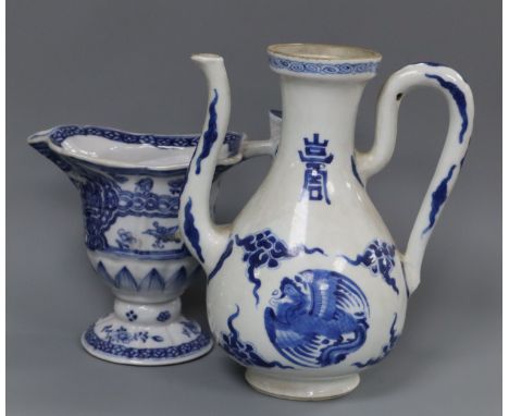 A Chinese Kangxi period blue and white wine pot and a Qianlong period helmet shaped milk jug Height of pot 16cm