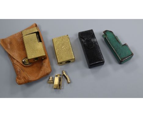 Three Dunhill lighter cases and two lighter bodies