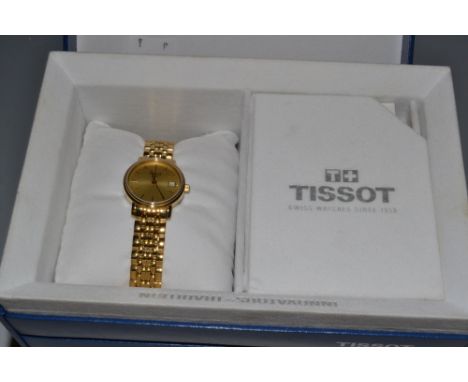 A Tissot lady's gold plated stainless steel wrist watch, gilt dial, baton markers, centre seconds, date aperture, articulated