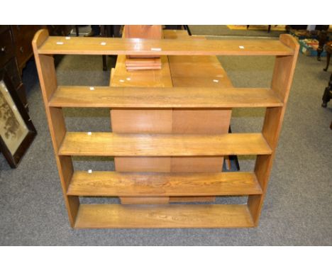 A light oak shelving unit, the 5 shelves with arched top