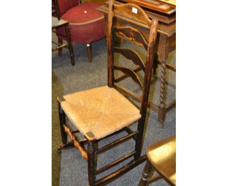 A Victorian rush seated ladder back rocking chair