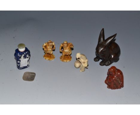 A Chinese bronzed model of a rabbit; an ivorine Japanese netsuke of an elder carrying a lantern; a pair of resin models of my