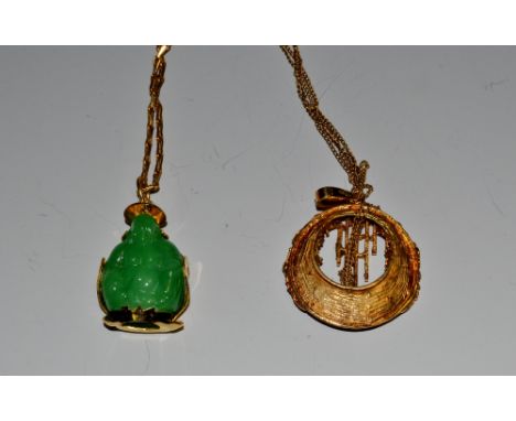 An unmarked yellow metal 1960's pendant, styulised textured ring and bar body, a Chinese green stone Buddah pendant