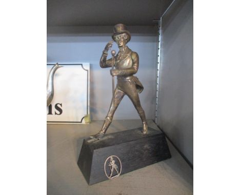 A silver plated figurine of Johnnie Walker (Scotch Whisky) mounted on a rectangular base, 21.5cm high, along with an oval sil