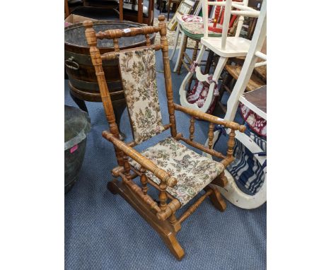 A vintage American walnut child's rocking chair with spindle supportsLocation: 
