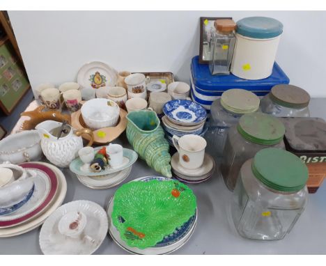 Early to mid 20th century household ceramics to include commemorative mugs and vintage tines and kitchen storage jarsLocation