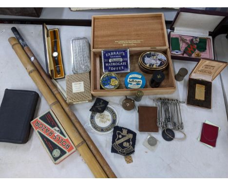 A mixed lot to include Rolls Razor, Excalibur ladies watch, vintage tins, boxed Sarome lighter, badges, fishing poles and oth