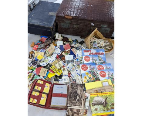 A selection of cigarette cards, matchstick boxes, playing cards, postcards and ephemera contained in two vintage casesLocatio