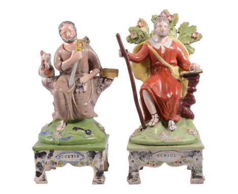 Two Staffordshire earthenware figures of St. Peter and St. Paul, in the manner of Obadiah Sherratt, St. Peter onbended knee, 