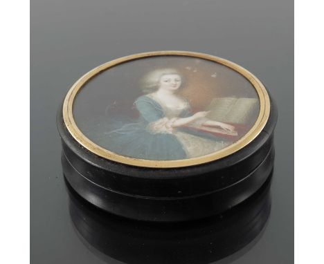 An 18th century French gold mounted tortoiseshell snuff box, the lid with a glazed portrait of a woman at a keyboard, 8cm dia