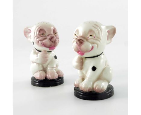 A pair of Royal Worcester Bonzo salt or pepper pots, 1930, modelled as the dog, puce marks, 8cm high