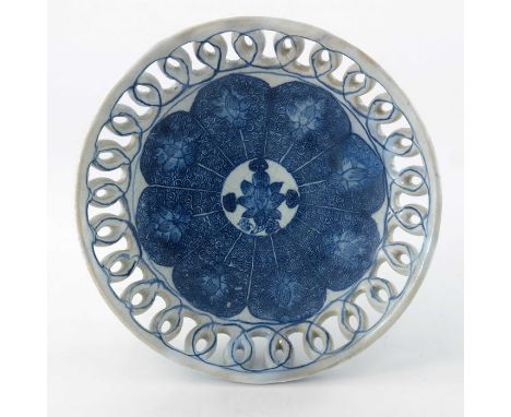 An English or Irish Delft dish, circa 1750, blue and white with reticulated lattice border, Chinese style foliate scroll lapp