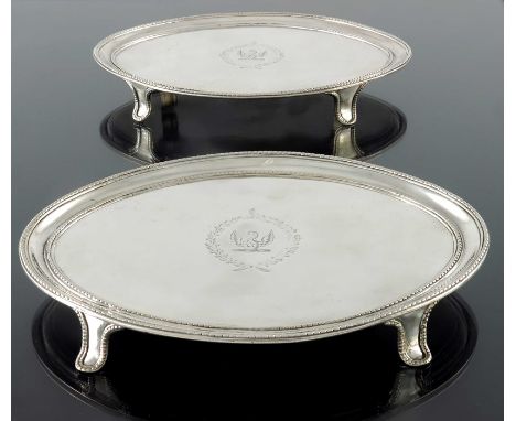 A pair of George III silver salvers, Thomas Chawner, London 1784, navette form, with beaded borders, on beaded bracket feet, 