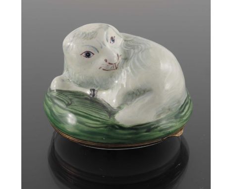 An 18th century Bilston enamel snuff box, modelled in relief as a coiled sheep on grassy tuft, the lid painted with floral bo
