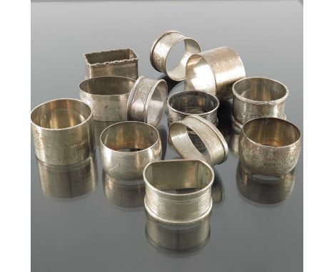A collection of twelve Victorian and later silver napkin rings, various dates and makers, plain and engine turned designs, ci