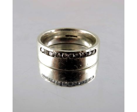 An 18 carat white gold and diamond ring, wedding band form set with a channel of ten stones, approx. size K, 6.6g