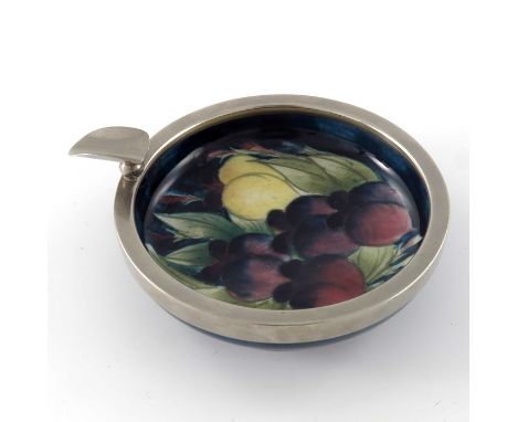 William Moorcroft, a Wisteria on blue ashtray, circa 1920, footed form with metal mount, impressed marks, 10cm diameter